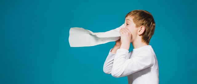 Kid sneezing possibly with influenza